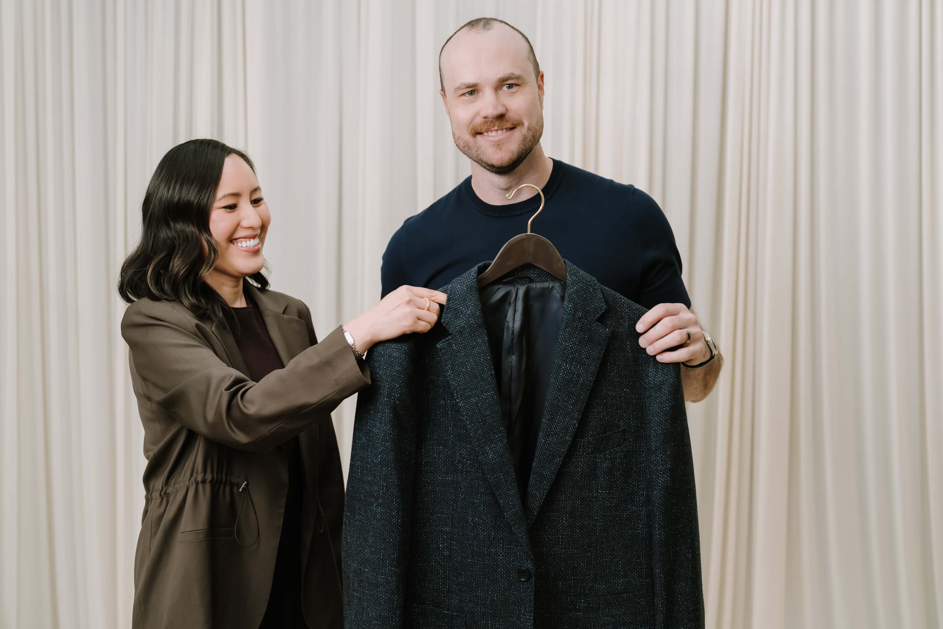 Gulinka Melbourne Personal Stylist holding a navy blazer up to a male client.