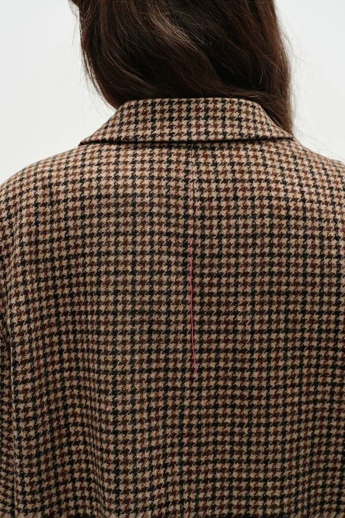 Back view of a brown houndstooth checked coat
