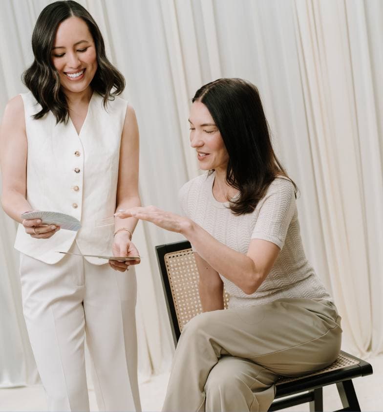 Gulinka showing colour swatches to a seated client