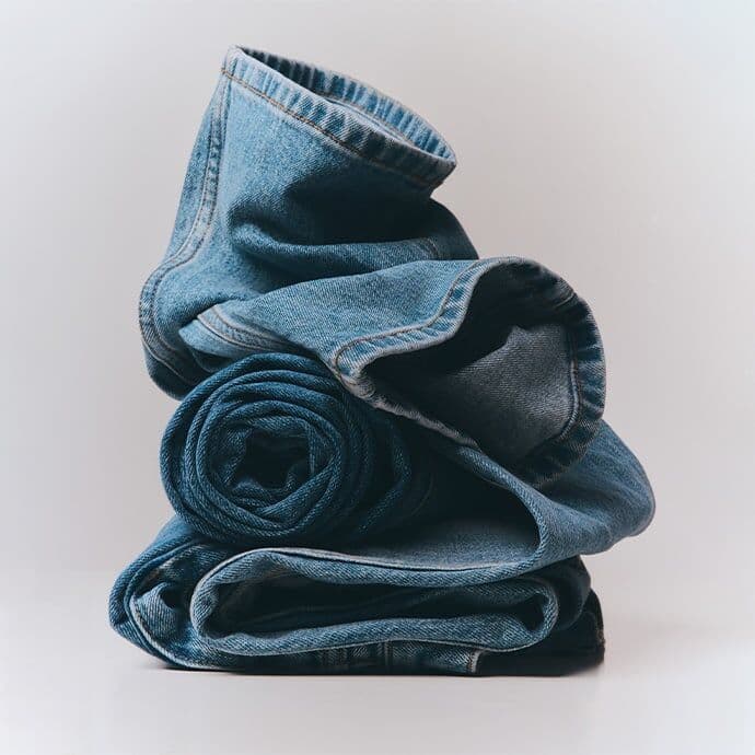 A stack of folded blue jeans