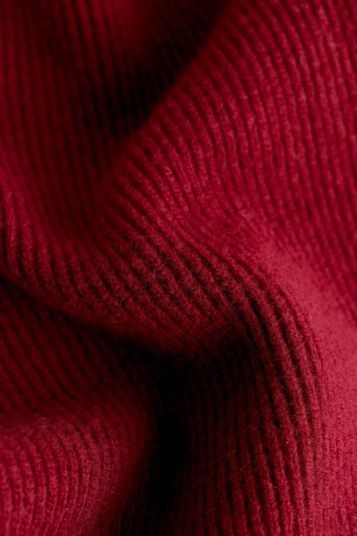 Deep red ribbed knit fabric in close-up